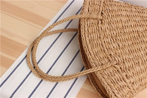 Close-up of hand-woven paper rope tote bag with fabric lining and straw texture details
