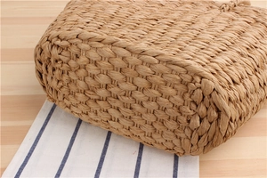 Macro shot of durable paper rope weaving pattern on a stylish straw shoulder bag
