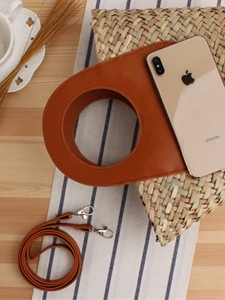 French style woven straw handbag with brown leather ring handles and phone for size reference
