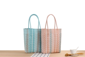 Close-up of woven waterproof plastic tote bags in striped blue and pink checkered patterns