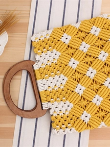 Handmade checkered cotton macrame tote bag with natural wooden handles on a rustic table