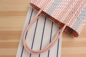 Detailed macro view of pastel pink and blue woven pattern on a waterproof shopping bag