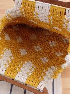 Handmade macrame tote bag with wooden handles and yellow geometric diamond patterns