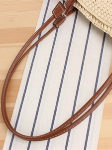 Large woven paper rope tote bag with brown leather shoulder straps for beach vacation