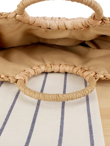 Handmade corn husk woven straw bag with round handles for beach vacations