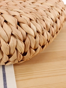 Handwoven natural corn husk tote bag with detailed texture for beach vacations