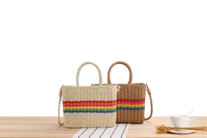 Detail of colorful rainbow stripe paper rope woven bag with wooden handles and strap