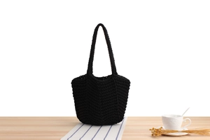 Close-up of thick cotton hand-woven bucket bag showing black herringbone texture