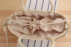 Detailed view of handmade woven paper rope bag with inner drawstring satin lining