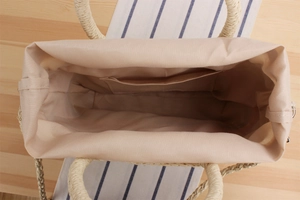 Internal view of a handwoven paper straw bag with fabric lining and interior pocket