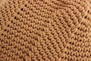 Close-up of the detailed handmade crochet texture and thick cotton rope weave of the bag