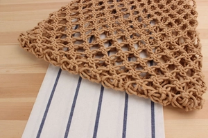 Detail shot of handcrafted hollow woven mesh bag showing intricate cotton knot texture
