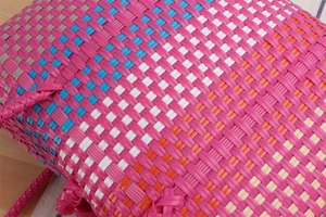 Close-up of colorful waterproof hand-woven plastic picnic basket with tight cross weave