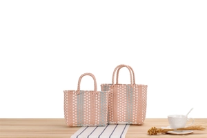 Detail view of pink and blue woven macaron baskets for picnics or home storage
