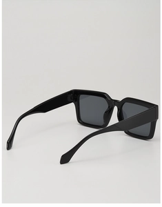 Detailed side view of thick black square sunglasses frames with wide temple design