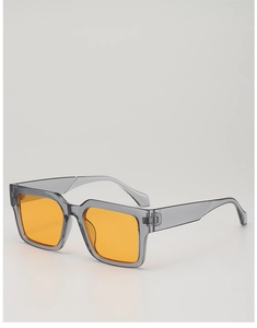 Detail view of bold square sunglasses featuring grey translucent frames and orange lenses