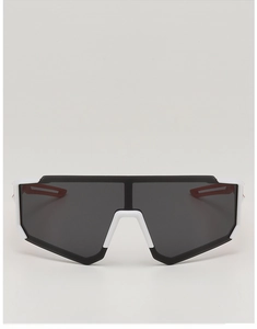 Front view of kids' sports sunglasses with black wrap-around lens and white nose pads