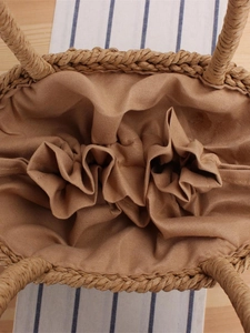 Top view of woven paper rope handbag with brown cotton lining and bohemian texture