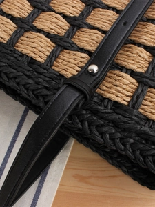 Large woven tote bag featuring natural straw pattern and black leather strap with stud