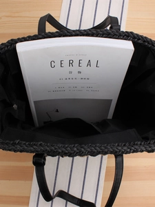 Black woven straw tote bag with inner lining and zipper pocket for daily commute