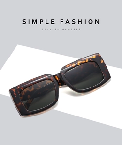 Macro detail of the thick tortoise shell texture and wide frames on square sunglasses