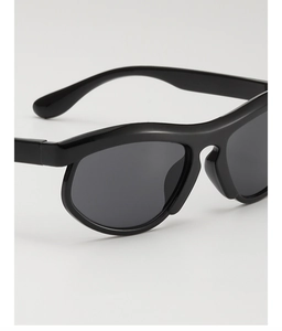 Detail of minimalist black thick frame kids sunglasses with dark grey lenses in side view