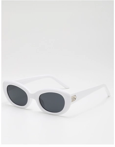 Detail view of white oval sunglasses with silver metal accents and dark UV lenses