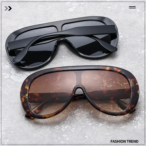 Close-up of oversized shield sunglasses in black and tortoise shell with CE model code