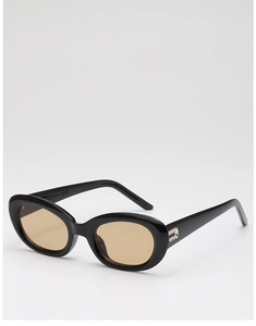 Detail view of oval sunglasses with black frames and tinted lenses with silver accents