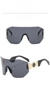 Macro detail of the deer head logo and gold hollow rings on black shield sunglasses