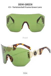 Detail of rimless green lens sunglasses with tortoiseshell arms and gold deer logo