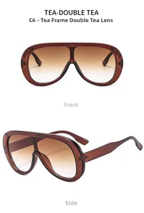 Detail view of oversized amber brown tortoiseshell frames with gradient tea lenses