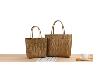 Close-up of bronze woven tote bags with diamond pattern in large and small sizes
