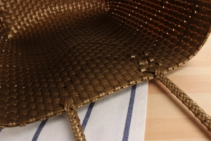 Macro view of woven tote bag showing durable brown texture and spacious interior detail