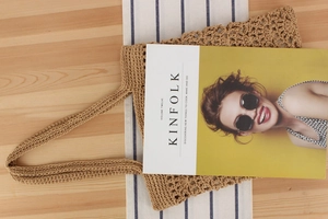 Detailed close-up of beige crochet tote bag texture with minimalist knit pattern