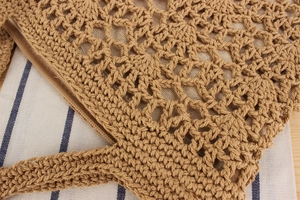 Detailed close-up of handmade woven hollow bag with secure zipper closure and soft lining