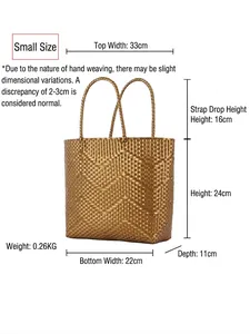 Small gold hand-woven tote bag with chevron pattern and dual handles on white background