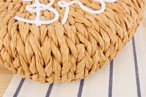 Vue détaillée de la texture en papier tressé avec broderie décorative en coton blanc