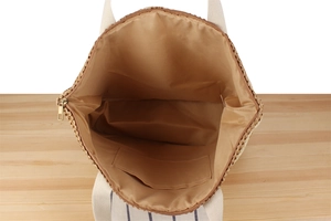 Top view of two-tone woven paper rope tote bag showing spacious lining and inner pocket