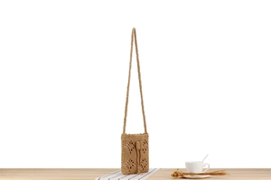 Detail of hand-woven cotton cord bag with hollow flower pattern and drawstring closure