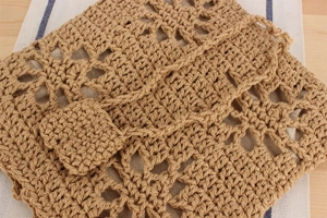 Close-up of khaki crochet cotton bag showing intricate hollow geometric weave patterns