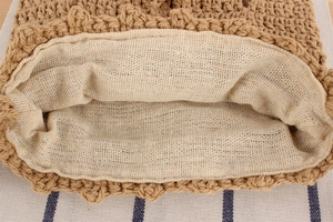 Close-up of hand-woven cotton rope bag showing detailed brown crochet texture and lining
