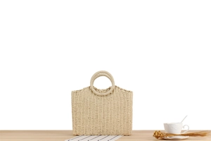 Detailed macro shot of weave texture and round circular handle on a straw bag