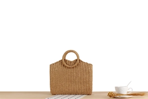 Detail of hand-woven straw tote bag with round handle and square body for summer beach