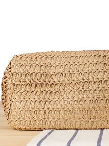 Dual-tone paper rope woven tote bag with detailed texture on a wooden surface