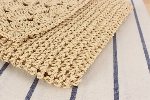 Close-up of handmade crochet paper rope bag showing intricate bohemian fan pattern texture