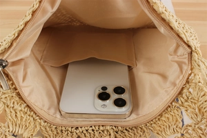 Detail view of woven paper rope bag interior with fabric lining and zip pocket