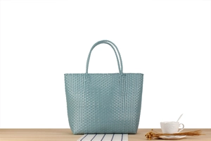 Detailed view of Morandi blue-grey woven tote bag featuring a checkered plastic pattern