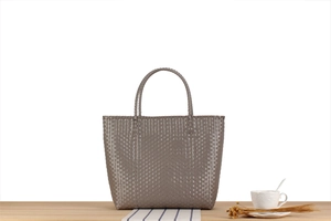 Close-up of hand-woven texture and sturdy handle on this macaron-style tote bag