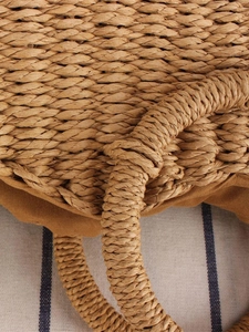 Handmade woven straw crossbody bag with round handle and natural brown texture finish